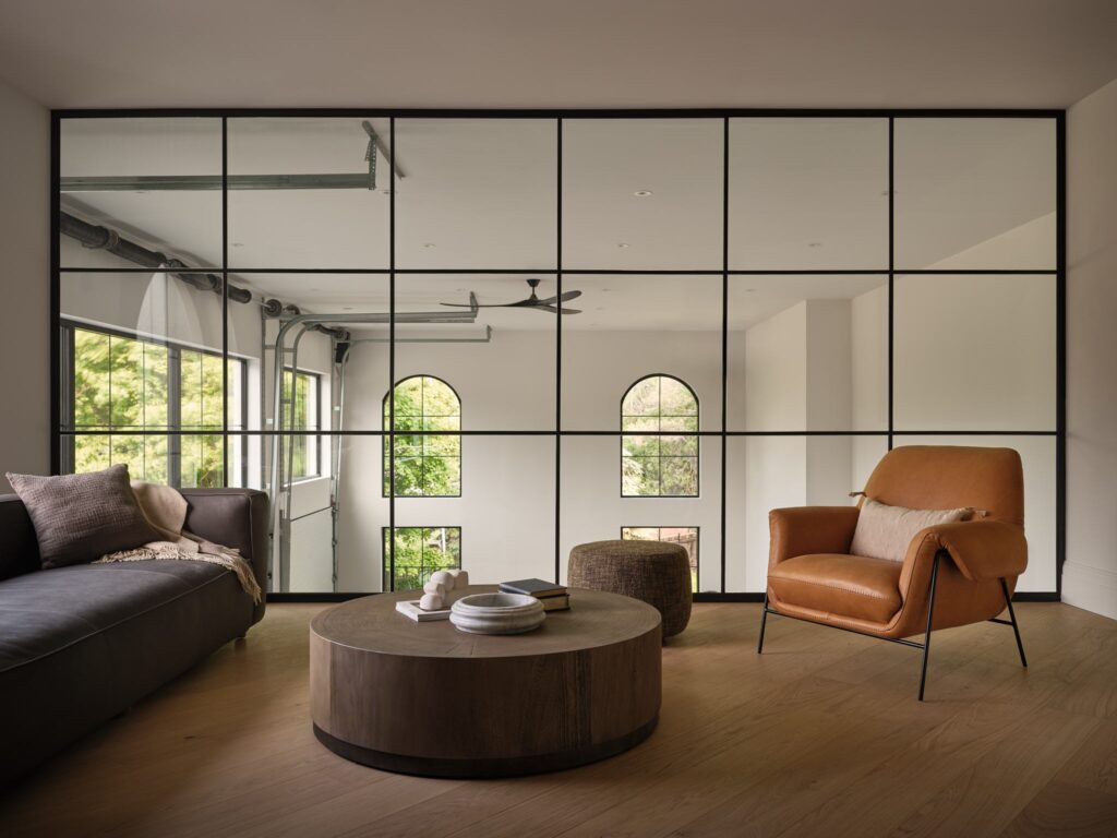 Sideroad sitting room framed by glass doors and arched windows